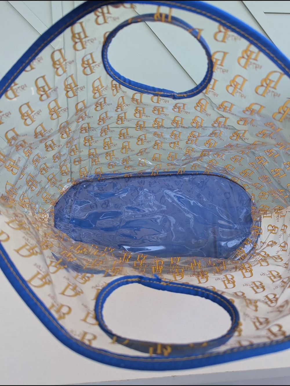 Dooney & Bourke Clear Tote with Blue Trim and Gold Logo Print